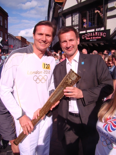 Jeremy Hunt poses with Olympian and torchbearer Roger Black